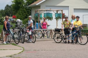 Six CWN cyclists with their bikes outside a small-town building