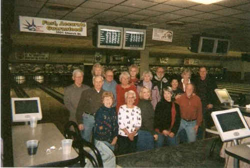 A large group of CWN members posing together at a bowling alley