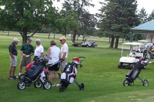 CWN golfers with their bags on a sunny golf course
