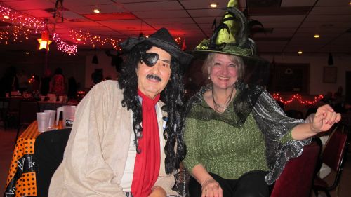 Two CWN members in pirate and witch costumes at the Halloween dance