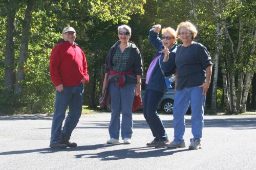Four CWN members striking playful poses on a hike in Door County
