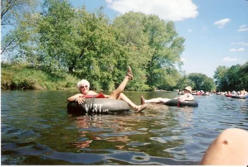 A CWN member relaxing on an inner tube floating down the Waupaca River